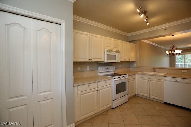 kitchen featuring pendant lighting, light countertops, white cabinets, a sink, and white appliances