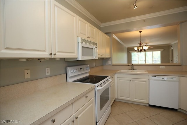 kitchen with white appliances, white cabinets, light countertops, pendant lighting, and a sink