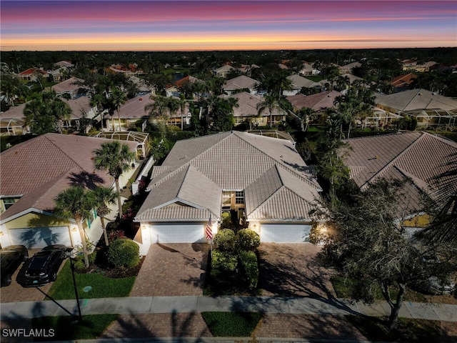 aerial view at dusk featuring a residential view