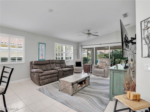 living room featuring light tile patterned floors, visible vents, baseboards, vaulted ceiling, and a ceiling fan