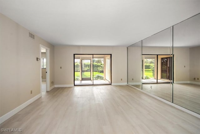 spare room with a healthy amount of sunlight and light wood-type flooring