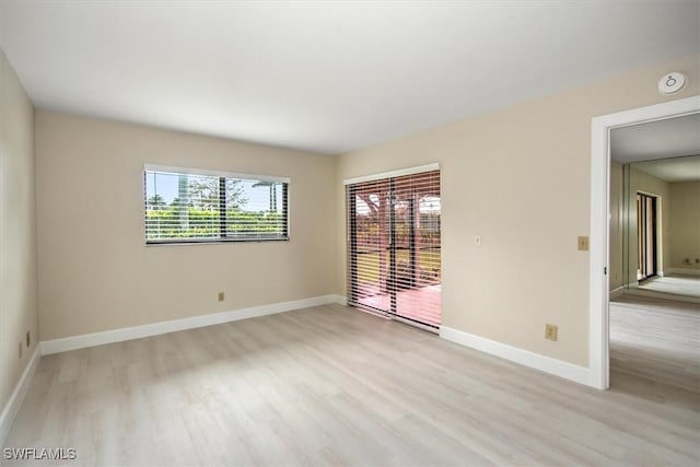 spare room featuring light wood-type flooring