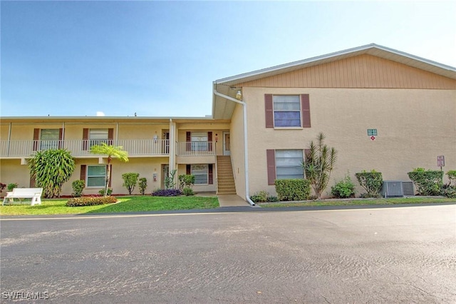 1100 Pondella Rd Unit 807, Cape Coral, FL 33909 - townhome / multi-family property with stairs, central AC unit, and stucco siding