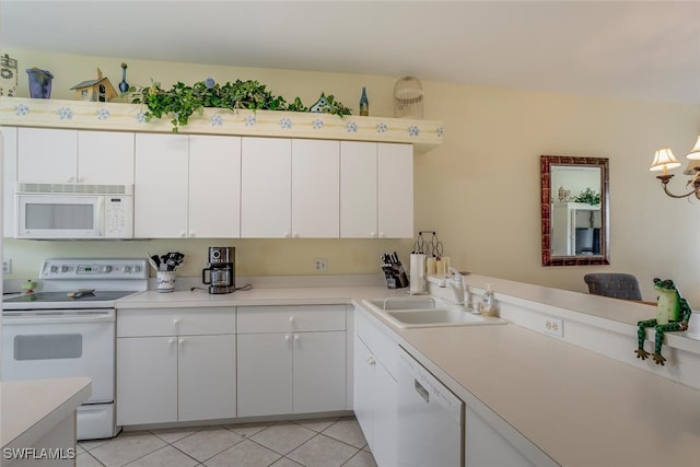 kitchen with white cabinetry, sink, white appliances, and light tile patterned floors