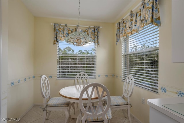 dining space with a chandelier and light tile patterned flooring