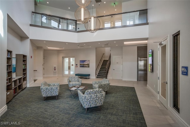 interior space with tile patterned flooring, a high ceiling, and elevator