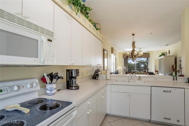 kitchen with sink, a chandelier, light tile patterned floors, white appliances, and white cabinets