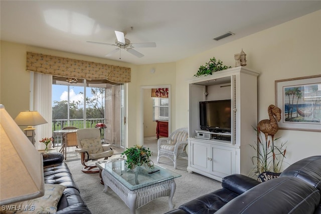 living room featuring light carpet and ceiling fan