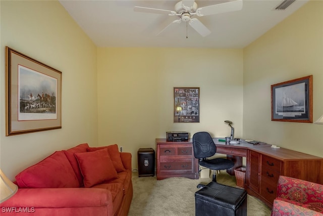 carpeted office space with ceiling fan