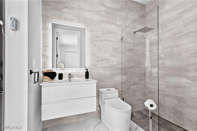 bathroom featuring vanity, toilet, tile walls, and a tile shower