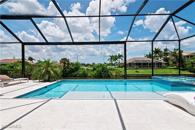 view of pool with an in ground hot tub, a lanai, and a patio area