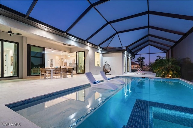 view of swimming pool featuring a lanai, a patio area, ceiling fan, and exterior bar