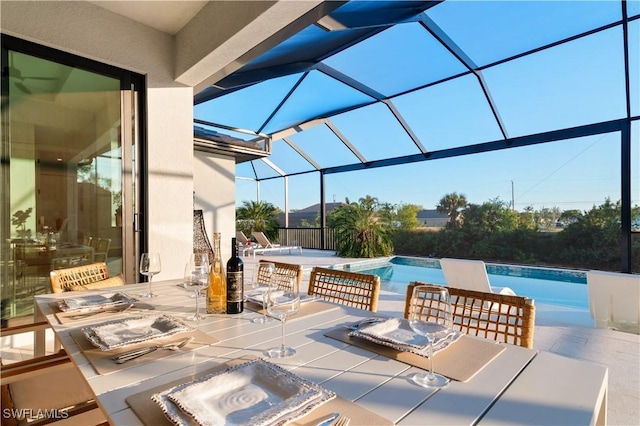 view of patio / terrace featuring a swimming pool with hot tub and glass enclosure