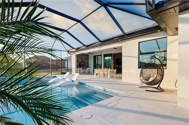 view of pool featuring a hot tub, a patio, a lanai, and ceiling fan