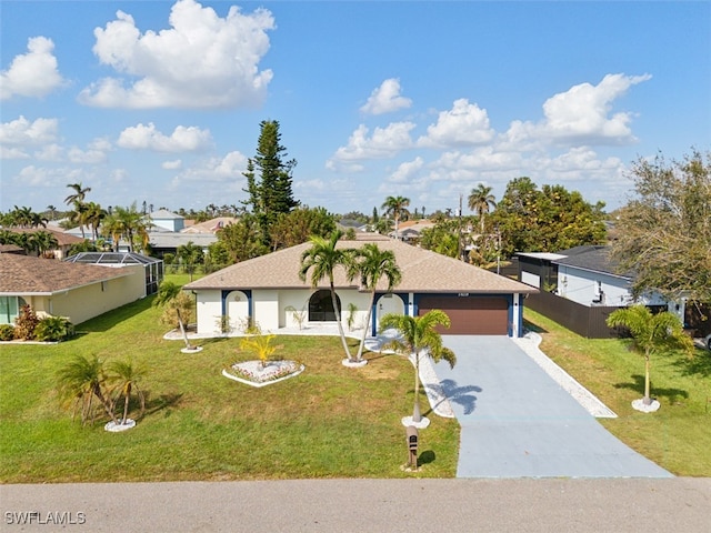 ranch-style house featuring a garage and a front lawn