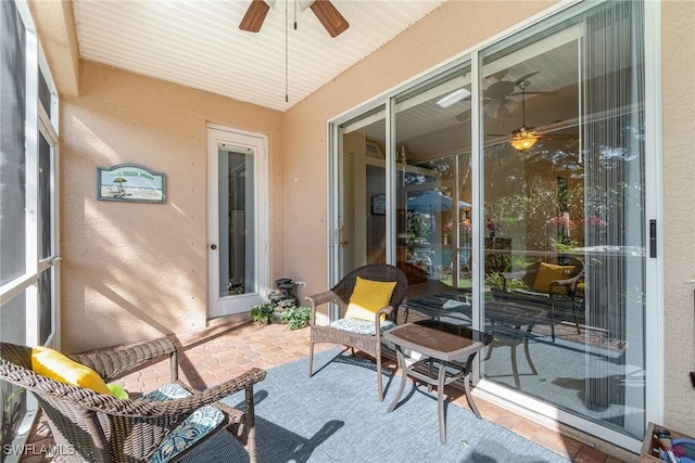 sunroom with a ceiling fan