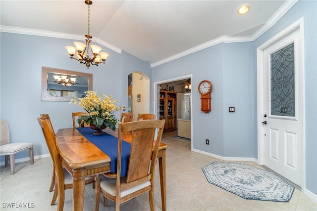 dining area featuring arched walkways, crown molding, and baseboards