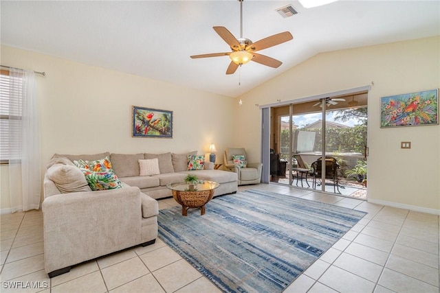 living room with lofted ceiling, light tile patterned floors, plenty of natural light, and visible vents