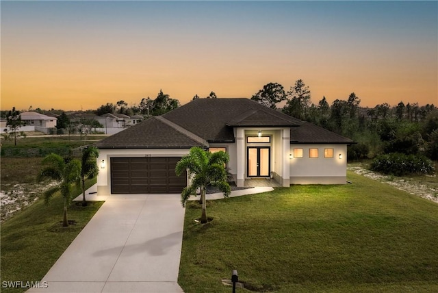 view of front facade featuring a garage and a yard