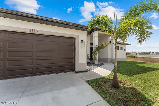 ranch-style home with a garage and a front yard