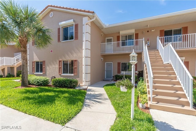 725 Saratoga Cir Unit A103, Naples, FL 34104 - view of building exterior with stairway