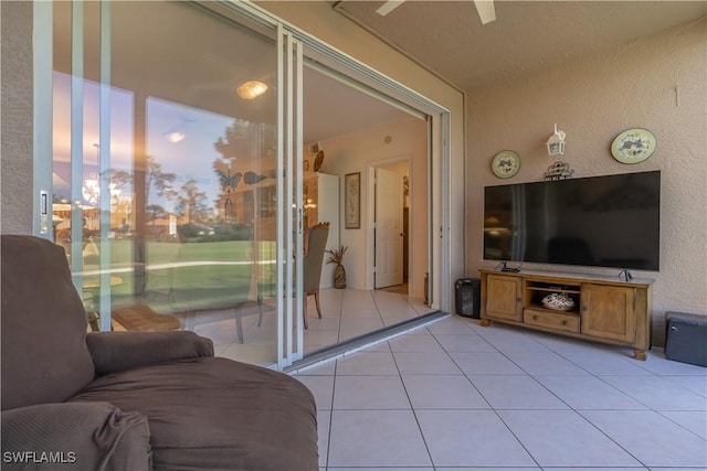 725 Saratoga Cir Unit A103, Naples, FL 34104 - living area featuring light tile patterned floors and a textured wall