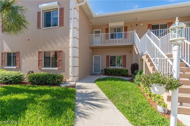 725 Saratoga Cir Unit A103, Naples, FL 34104 - view of building exterior with stairway