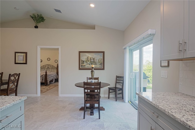 dining space featuring vaulted ceiling