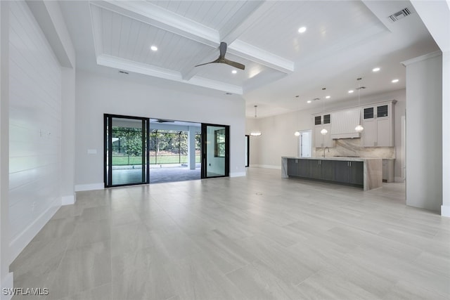 unfurnished living room with baseboards, visible vents, ceiling fan, and coffered ceiling