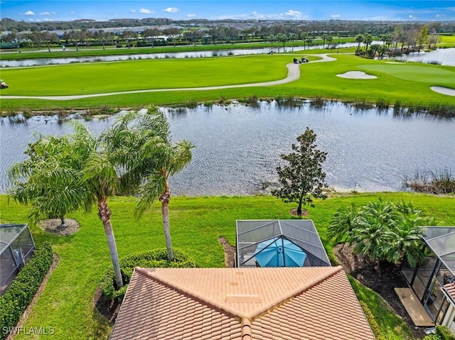 drone / aerial view featuring view of golf course and a water view