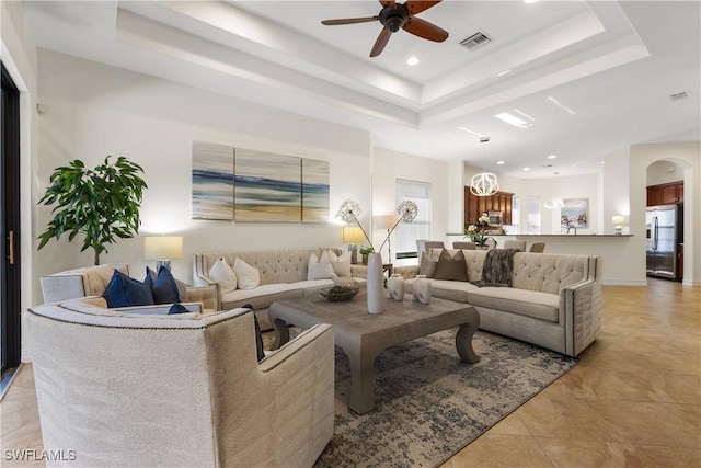 living room with a healthy amount of sunlight and a tray ceiling