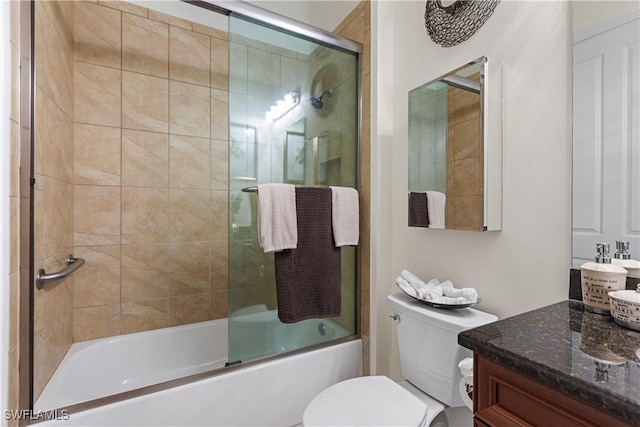 full bathroom featuring bath / shower combo with glass door, vanity, and toilet