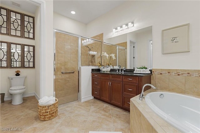 full bathroom featuring vanity, tile patterned floors, shower with separate bathtub, and toilet