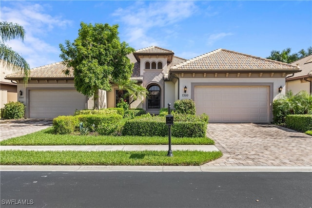 mediterranean / spanish home featuring a garage