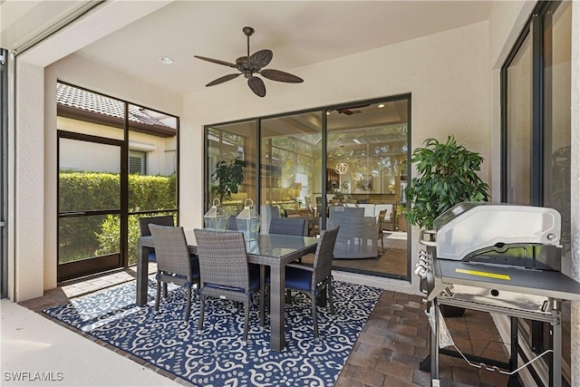 sunroom / solarium featuring ceiling fan