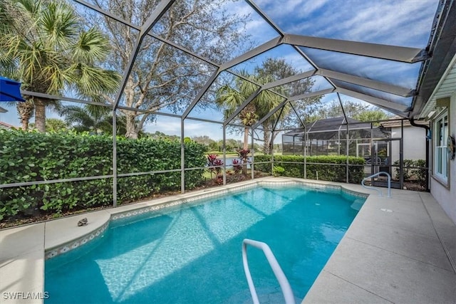 view of pool with a lanai and a patio area