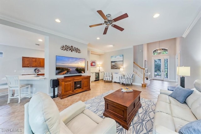 tiled living room with french doors, ceiling fan, crown molding, and sink