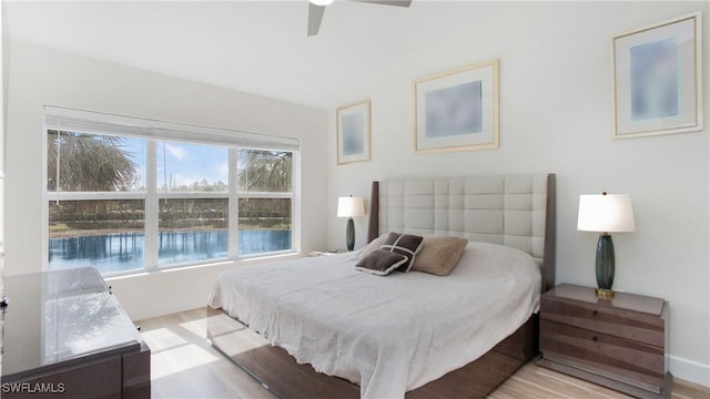 bedroom with ceiling fan and light wood-style flooring