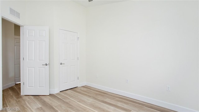 unfurnished bedroom featuring light wood-type flooring, visible vents, and baseboards