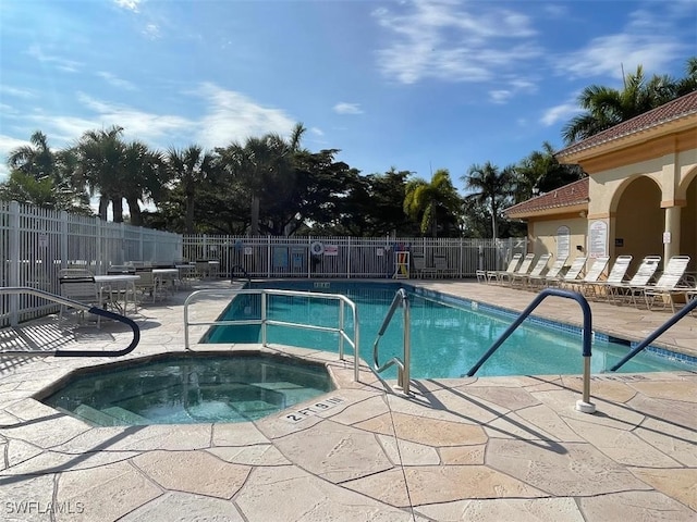 view of pool with a community hot tub and a patio