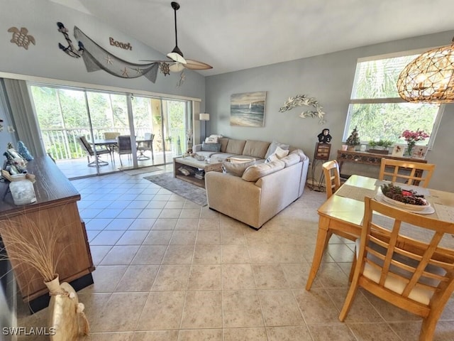 tiled living room featuring ceiling fan and vaulted ceiling