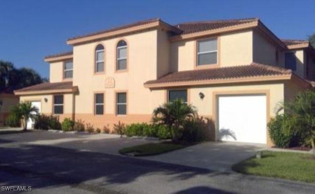 15495 Bellamar Cir Unit 2222, Fort Myers, FL 33908 - view of front of house featuring concrete driveway, an attached garage, and stucco siding