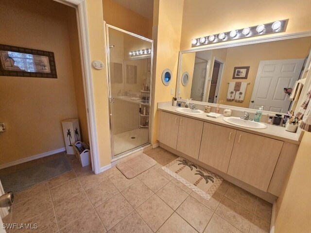 15495 Bellamar Cir Unit 2222, Fort Myers, FL 33908 - bathroom featuring a stall shower, tile patterned flooring, double vanity, and baseboards