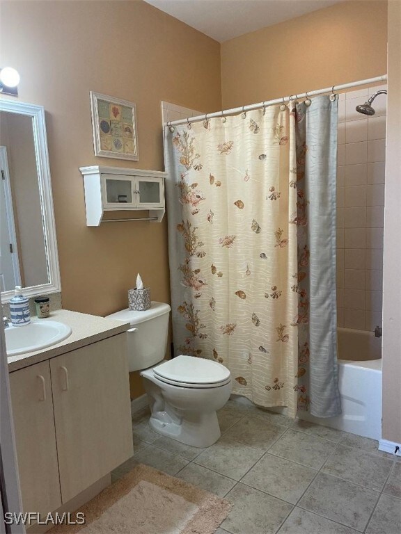 15495 Bellamar Cir Unit 2222, Fort Myers, FL 33908 - bathroom featuring toilet, tile patterned floors, vanity, and shower / bath combination with curtain