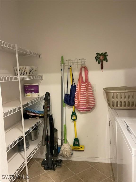 15495 Bellamar Cir Unit 2222, Fort Myers, FL 33908 - washroom featuring washer and clothes dryer, tile patterned floors, and baseboards