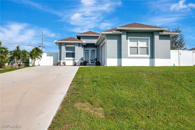 view of front of home featuring french doors and a front lawn