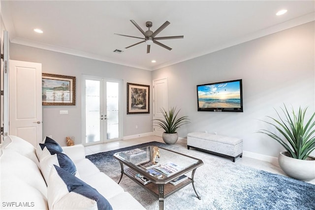 tiled living room with ornamental molding, ceiling fan, and french doors