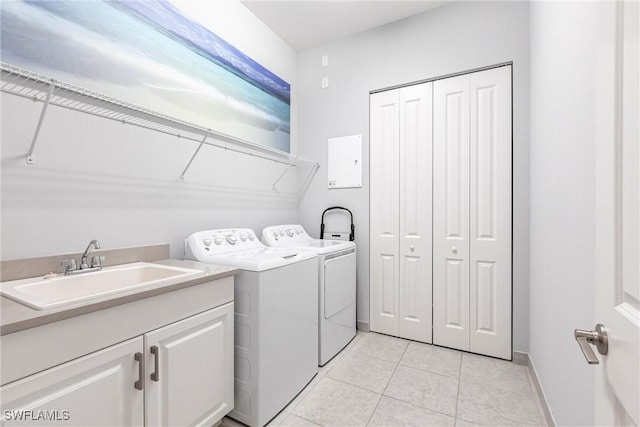 washroom featuring cabinets, separate washer and dryer, sink, and light tile patterned floors