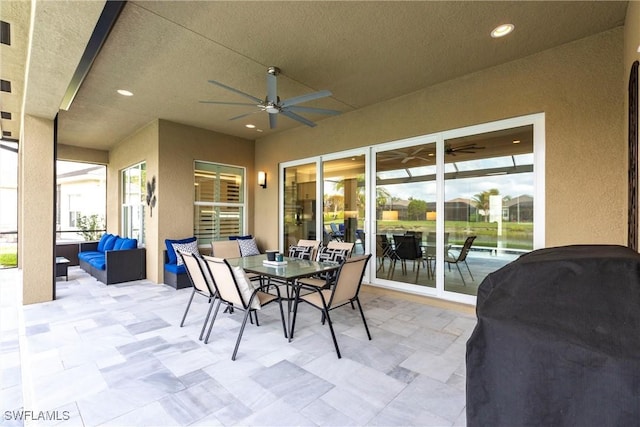 view of patio / terrace with a water view, ceiling fan, and an outdoor hangout area