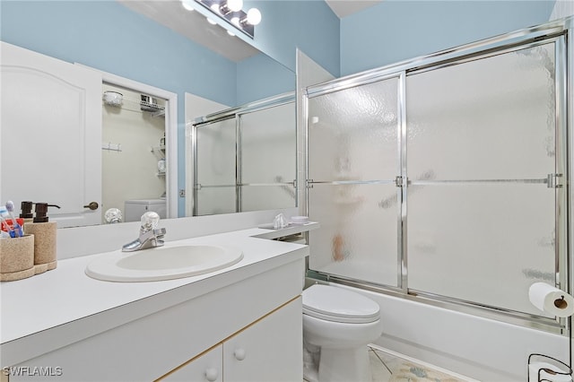 full bathroom with enclosed tub / shower combo, vanity, and toilet